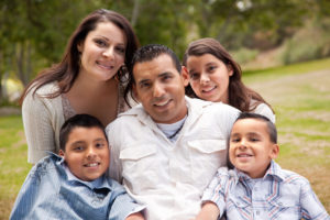 Happy Hispanic Family Portrait In the Park.